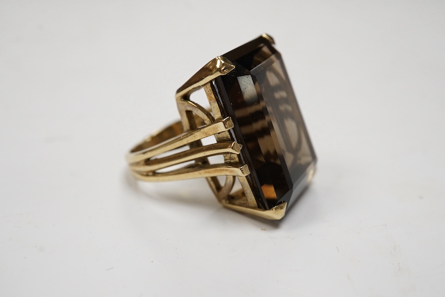 A 9ct and large single stone emerald cut smoky quartz set dress ring, size P, gross weight 14.9 grams. Condition - good